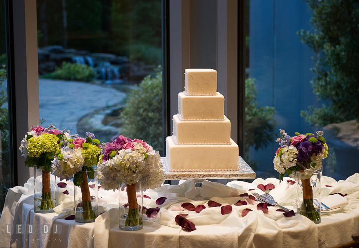 Wedding cake by Layered Cake Patisserie and floral bouquets by Flowers by Sher. Falls Church Virginia 2941 Restaurant wedding reception photo, by wedding photographers of Leo Dj Photography. http://leodjphoto.com