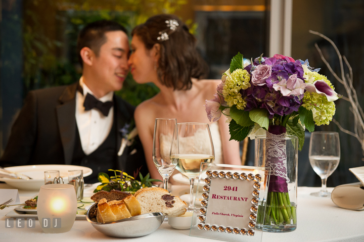 Bride and Groom cuddling at the sweet heart table. Falls Church Virginia 2941 Restaurant wedding reception photo, by wedding photographers of Leo Dj Photography. http://leodjphoto.com