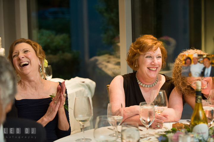 Bride's Mother and Aunt laughing listening to Maid of Honor's speech. Falls Church Virginia 2941 Restaurant wedding reception photo, by wedding photographers of Leo Dj Photography. http://leodjphoto.com