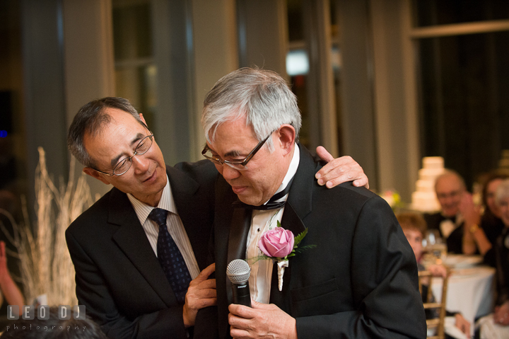 Groom's Uncle trying to comfort Father of Groom. Falls Church Virginia 2941 Restaurant wedding reception photo, by wedding photographers of Leo Dj Photography. http://leodjphoto.com