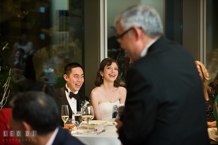 Bride and Groom laughing listening to Father of Groom's toast speech. Falls Church Virginia 2941 Restaurant wedding reception photo, by wedding photographers of Leo Dj Photography. http://leodjphoto.com