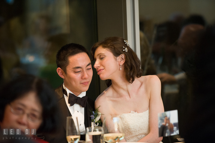 Groom shed a tear while Bride tries to comfort him. Falls Church Virginia 2941 Restaurant wedding reception photo, by wedding photographers of Leo Dj Photography. http://leodjphoto.com