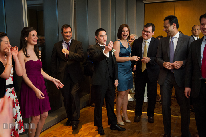 Groom invites others to dance on the dance floor. Falls Church Virginia 2941 Restaurant wedding reception photo, by wedding photographers of Leo Dj Photography. http://leodjphoto.com