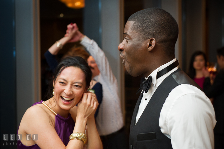 Best Man and Groom's sister laughing and having fun. Falls Church Virginia 2941 Restaurant wedding reception photo, by wedding photographers of Leo Dj Photography. http://leodjphoto.com