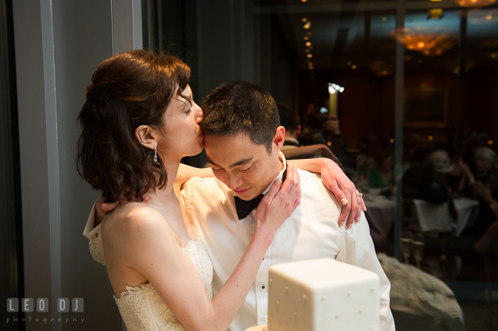 Bride kissed Groom on the forehead. Falls Church Virginia 2941 Restaurant wedding reception photo, by wedding photographers of Leo Dj Photography. http://leodjphoto.com