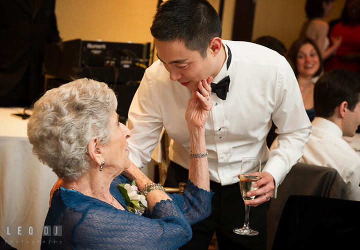 Bride's grandmother talking to Groom. Falls Church Virginia 2941 Restaurant wedding reception photo, by wedding photographers of Leo Dj Photography. http://leodjphoto.com