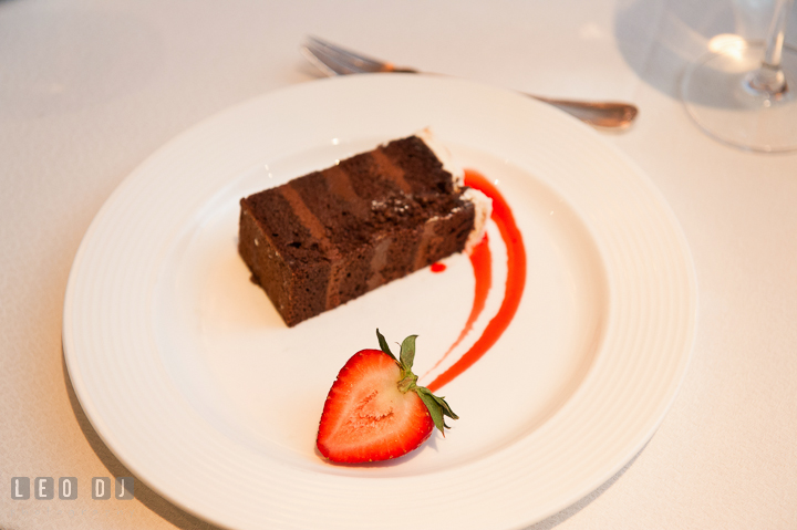 A slice of chocolate wedding cake with strawberry. Falls Church Virginia 2941 Restaurant wedding reception photo, by wedding photographers of Leo Dj Photography. http://leodjphoto.com