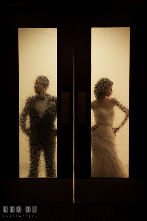 Silhouette of Bride and Groom behind glass doors. Falls Church Virginia 2941 Restaurant wedding reception photo, by wedding photographers of Leo Dj Photography. http://leodjphoto.com