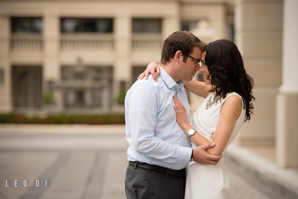 Engaged couple holding each other close. Annapolis Eastern Shore Maryland pre-wedding engagement photo session at downtown, by wedding photographers of Leo Dj Photography. http://leodjphoto.com