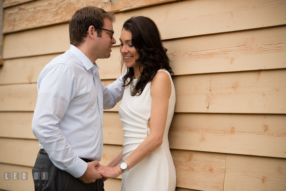 Engaged girl holding hands with her fiancé. Annapolis Eastern Shore Maryland pre-wedding engagement photo session at downtown, by wedding photographers of Leo Dj Photography. http://leodjphoto.com