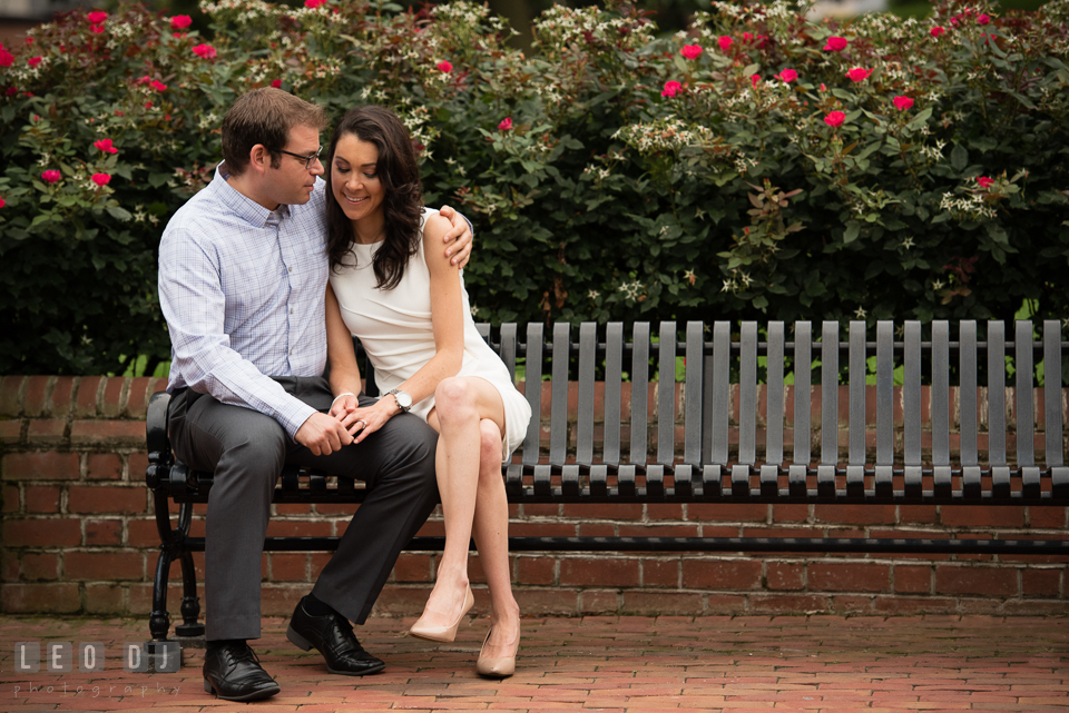 Engaged girl cuddled with her fiance on a bench. Annapolis Eastern Shore Maryland pre-wedding engagement photo session at downtown, by wedding photographers of Leo Dj Photography. http://leodjphoto.com