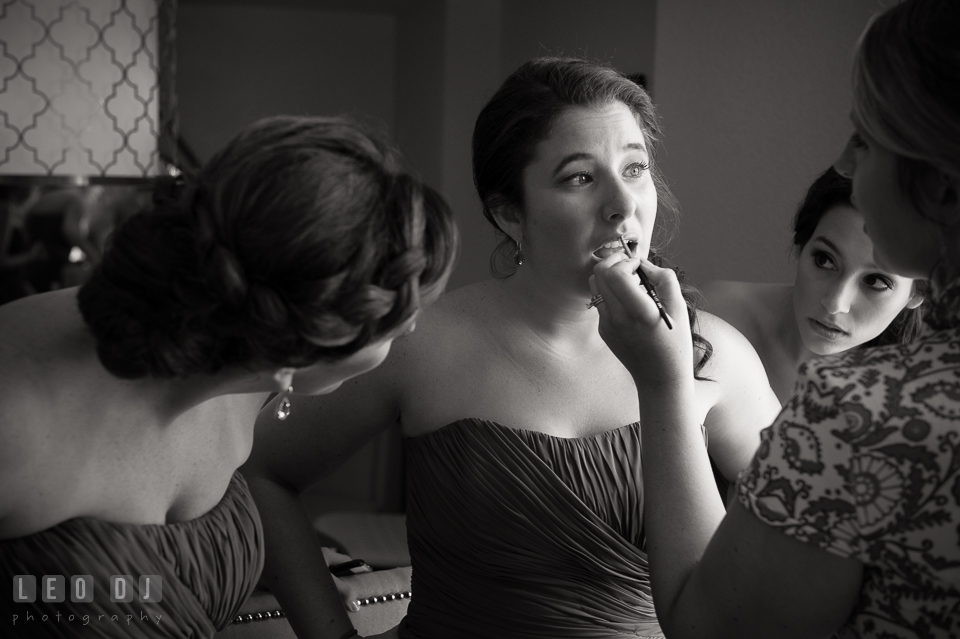 Maid of honor and bridesmaid watching another bridesmaid getting make up. Loews Annapolis Hotel Maryland wedding, by wedding photographers of Leo Dj Photography. http://leodjphoto.com