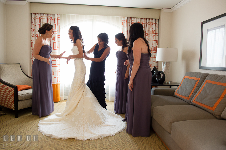 Mother of Bride help daughter zip up wedding gown. Loews Annapolis Hotel Maryland wedding, by wedding photographers of Leo Dj Photography. http://leodjphoto.com