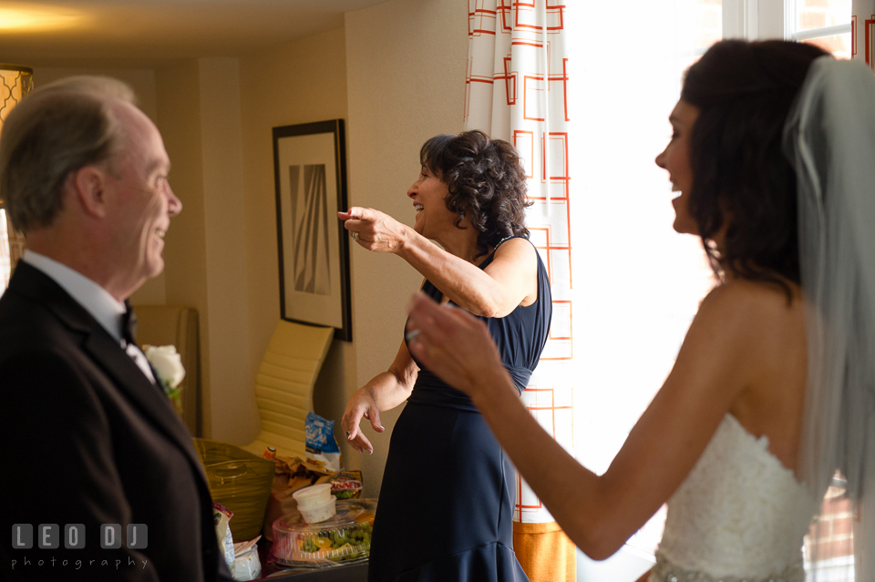 Mother of Bride pointing to Father of Bride during first look with daughter. Loews Annapolis Hotel Maryland wedding, by wedding photographers of Leo Dj Photography. http://leodjphoto.com