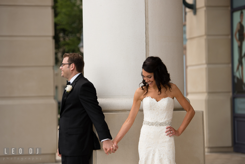 Bride and Groom holding hands and smiling before their first look. Loews Annapolis Hotel Maryland wedding, by wedding photographers of Leo Dj Photography. http://leodjphoto.com