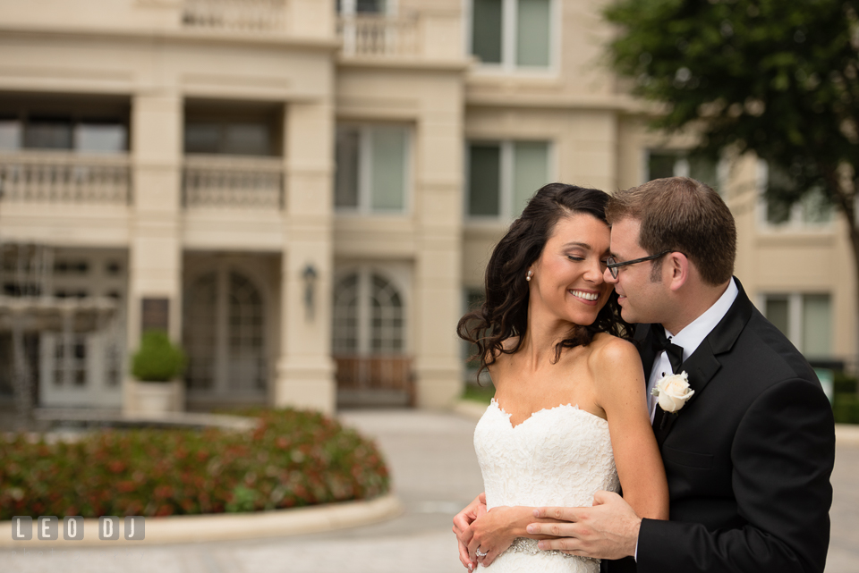 Bride cuddling with Groom. Loews Annapolis Hotel Maryland wedding, by wedding photographers of Leo Dj Photography. http://leodjphoto.com