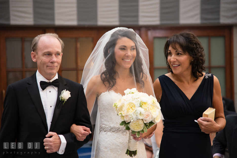 Father and Mother of the Bride escorting their daughter walking down the aisle. Loews Annapolis Hotel Maryland wedding, by wedding photographers of Leo Dj Photography. http://leodjphoto.com