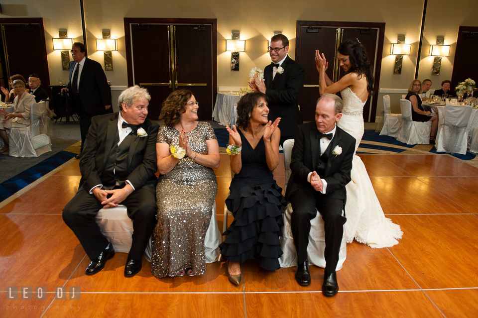 Parents sitting and circled by Bride and Groom during the Mezinke Tanz ritual . Loews Annapolis Hotel Maryland wedding, by wedding photographers of Leo Dj Photography. http://leodjphoto.com