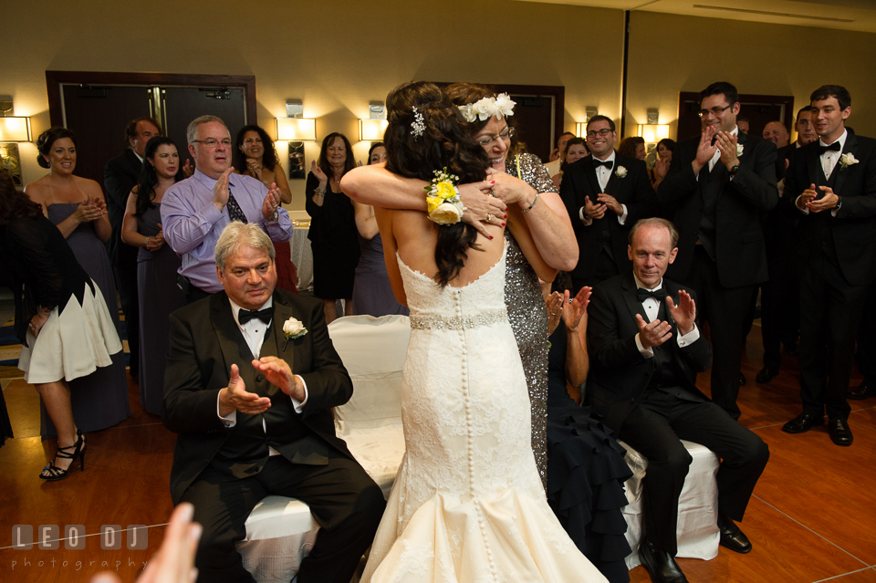 Mother of Groom hugging Bride during the crowning ritual. Loews Annapolis Hotel Maryland wedding, by wedding photographers of Leo Dj Photography. http://leodjphoto.com