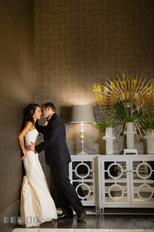 Bride and Groom leaning on a wall, almost kissing. Loews Annapolis Hotel Maryland wedding, by wedding photographers of Leo Dj Photography. http://leodjphoto.com