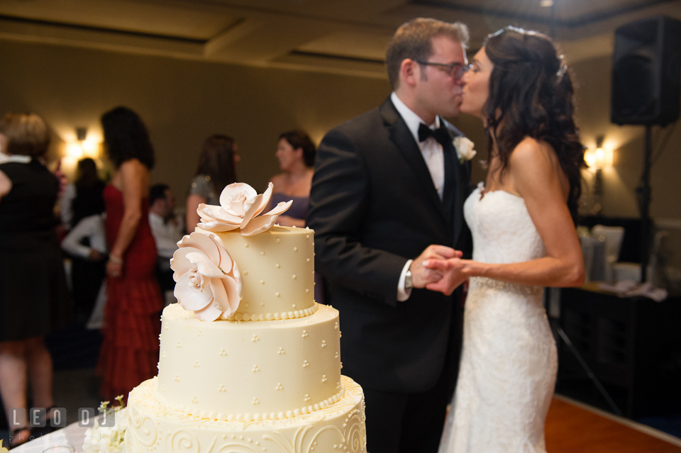 Bride and Groom kissing after the cake cutting. Loews Annapolis Hotel Maryland wedding, by wedding photographers of Leo Dj Photography. http://leodjphoto.com