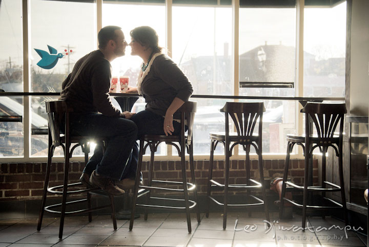 Engaged couple almost kissed inside Starbucks coffee shop. Pre-wedding or engagement photo session at Annapolis city harbor, Maryland, Eastern Shore, by wedding photographers of Leo Dj Photography.