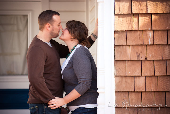 Engaged guy cuddling with his fiancée. Pre-wedding or engagement photo session at Annapolis city harbor, Maryland, Eastern Shore, by wedding photographers of Leo Dj Photography.