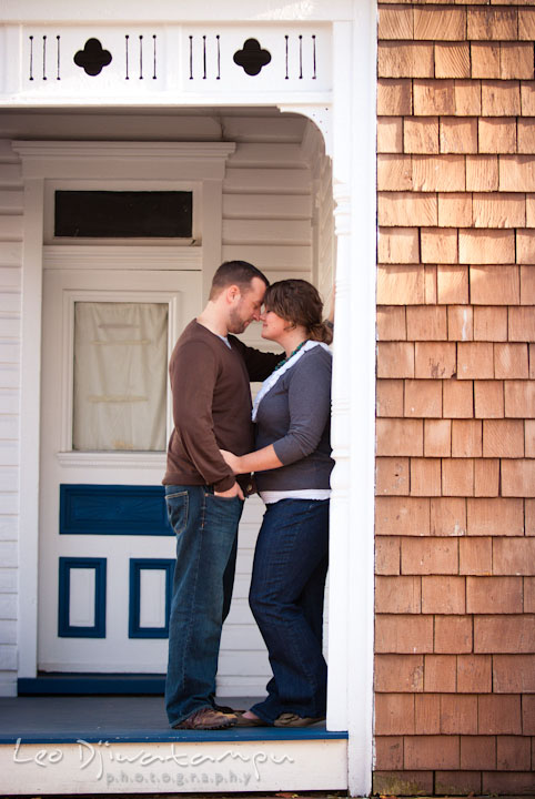 Engaged guy cuddling with his fiancee. Pre-wedding or engagement photo session at Annapolis city harbor, Maryland, Eastern Shore, by wedding photographers of Leo Dj Photography.