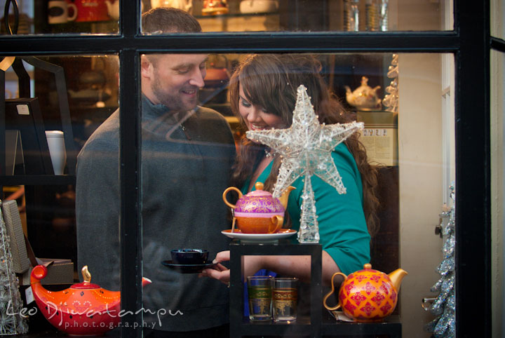 Engaged guy and girl browsing Christmas ornaments. Pre-wedding or engagement photo session at Annapolis city harbor, Maryland, Eastern Shore, by wedding photographers of Leo Dj Photography.