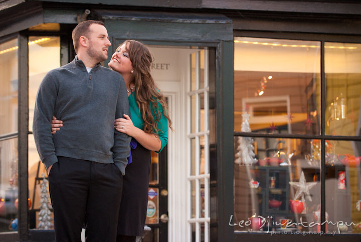 Engaged guy and his fiancee in front of a tea shop. Pre-wedding or engagement photo session at Annapolis city harbor, Maryland, Eastern Shore, by wedding photographers of Leo Dj Photography.