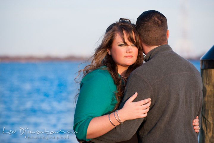 Engaged girl hugging her fiance. Pre-wedding or engagement photo session at Annapolis city harbor, Maryland, Eastern Shore, by wedding photographers of Leo Dj Photography.