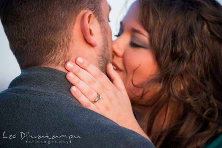 Engaged guy and girl almost kissed and showing engagement ring. Pre-wedding or engagement photo session at Annapolis city harbor, Maryland, Eastern Shore, by wedding photographers of Leo Dj Photography.