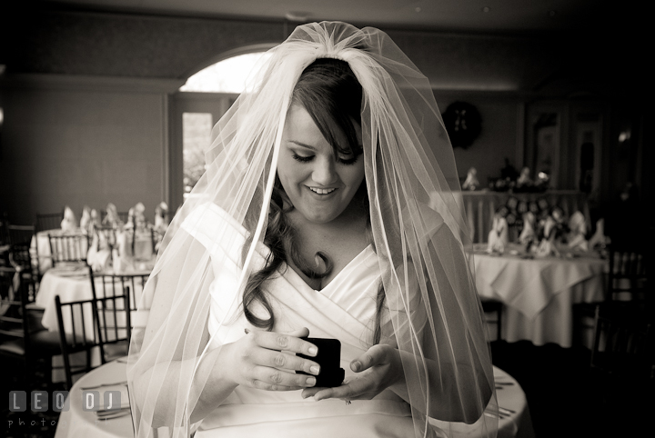 Bride opening gift earrings from the Groom. The Ballroom at The Chesapeake Inn wedding ceremony photos, Chesapeake City, Maryland by photographers of Leo Dj Photography.