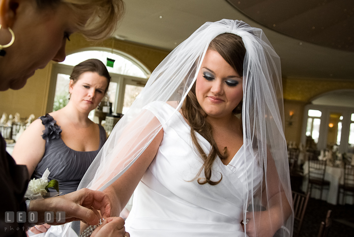 Mother of the Bride helping putting on bracelet for her daughter. The Ballroom at The Chesapeake Inn wedding ceremony photos, Chesapeake City, Maryland by photographers of Leo Dj Photography.