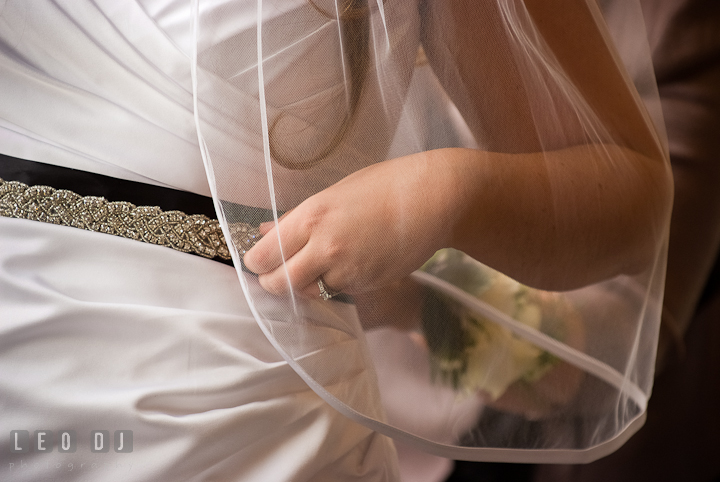 Bride adjusting her belt. The Ballroom at The Chesapeake Inn wedding ceremony photos, Chesapeake City, Maryland by photographers of Leo Dj Photography.