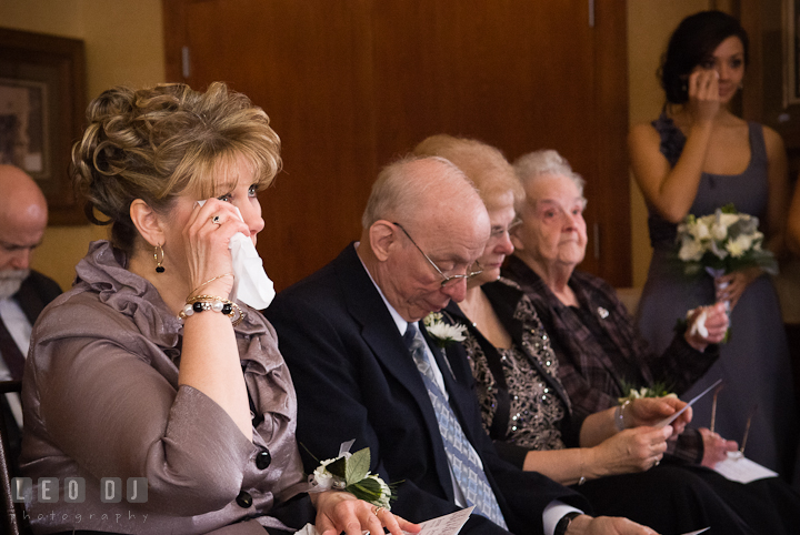 Mother of Bride wiping of tears from her eyes. The Ballroom at The Chesapeake Inn wedding ceremony photos, Chesapeake City, Maryland by photographers of Leo Dj Photography.