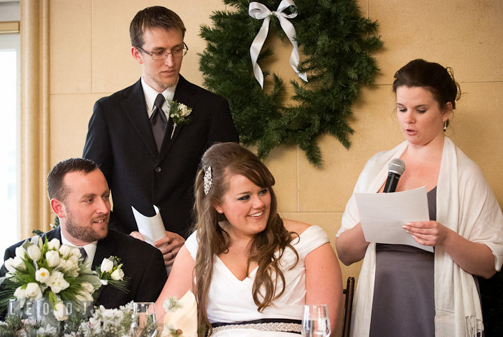 Bride and Groom listening to Matron of Honor's speech. The Ballroom at The Chesapeake Inn wedding reception photos, Chesapeake City, Maryland by photographers of Leo Dj Photography.