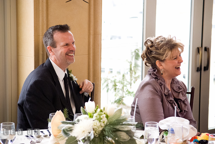 Father and Mother of Bride laughing listening to speech. The Ballroom at The Chesapeake Inn wedding reception photos, Chesapeake City, Maryland by photographers of Leo Dj Photography.