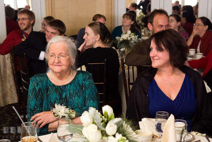 Grandmother and Mother of Groom smiling listening to speech. The Ballroom at The Chesapeake Inn wedding reception photos, Chesapeake City, Maryland by photographers of Leo Dj Photography.