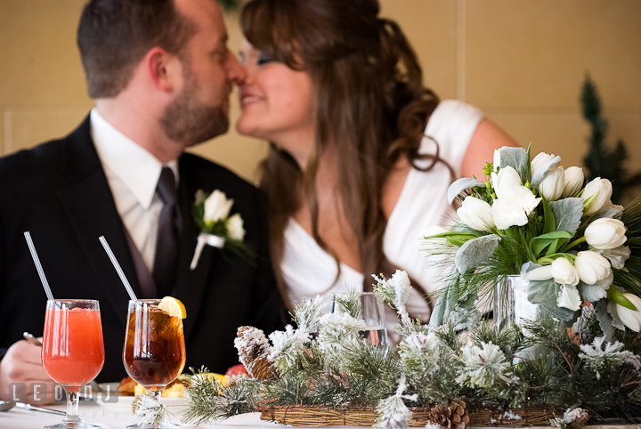 Bride and Groom almost kissed at the sweetheart table. The Ballroom at The Chesapeake Inn wedding reception photos, Chesapeake City, Maryland by photographers of Leo Dj Photography.