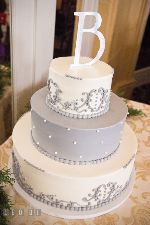 Winter color themed cake with metal letter topper. The Ballroom at The Chesapeake Inn wedding reception photos, Chesapeake City, Maryland by photographers of Leo Dj Photography.