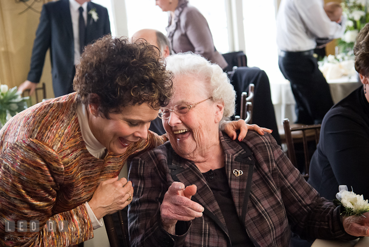 Grandmother and guest laughing. The Ballroom at The Chesapeake Inn wedding reception photos, Chesapeake City, Maryland by photographers of Leo Dj Photography.