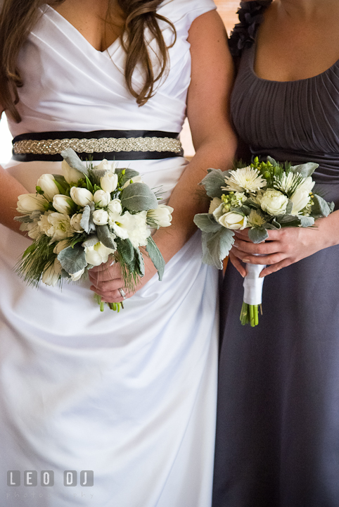 Bride and Matron of Honor holding their flower bouquet. The Ballroom at The Chesapeake Inn wedding reception photos, Chesapeake City, Maryland by photographers of Leo Dj Photography.