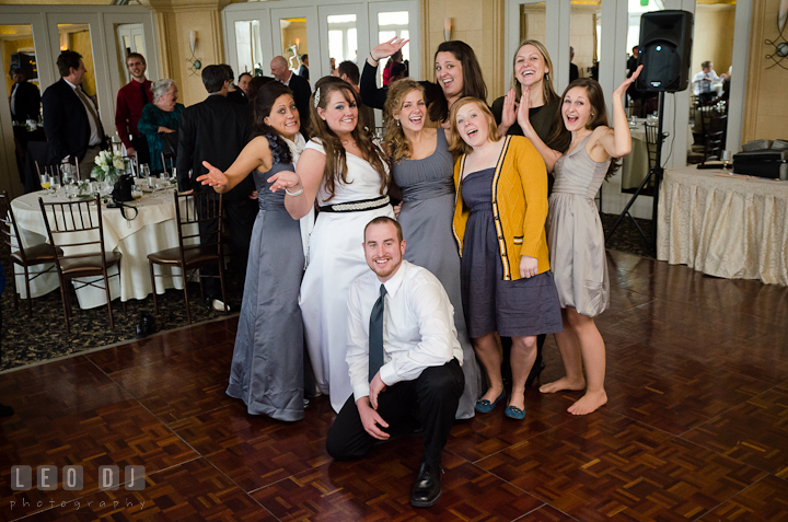 Bride posing with college alumni friends. The Ballroom at The Chesapeake Inn wedding reception photos, Chesapeake City, Maryland by photographers of Leo Dj Photography.