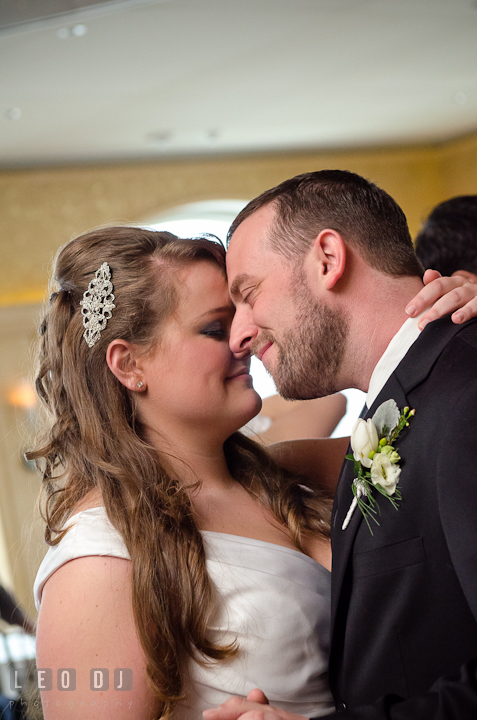 Bride and Groom smiling while dancing close together. The Ballroom at The Chesapeake Inn wedding reception photos, Chesapeake City, Maryland by photographers of Leo Dj Photography.