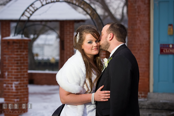 Groom kissed Bride's cheek. The Ballroom at The Chesapeake Inn wedding reception photos, Chesapeake City, Maryland by photographers of Leo Dj Photography.