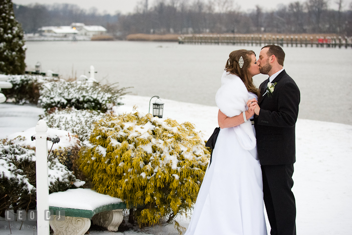 Bride and Groom kissing in a wintry backdrop. The Ballroom at The Chesapeake Inn wedding reception photos, Chesapeake City, Maryland by photographers of Leo Dj Photography.