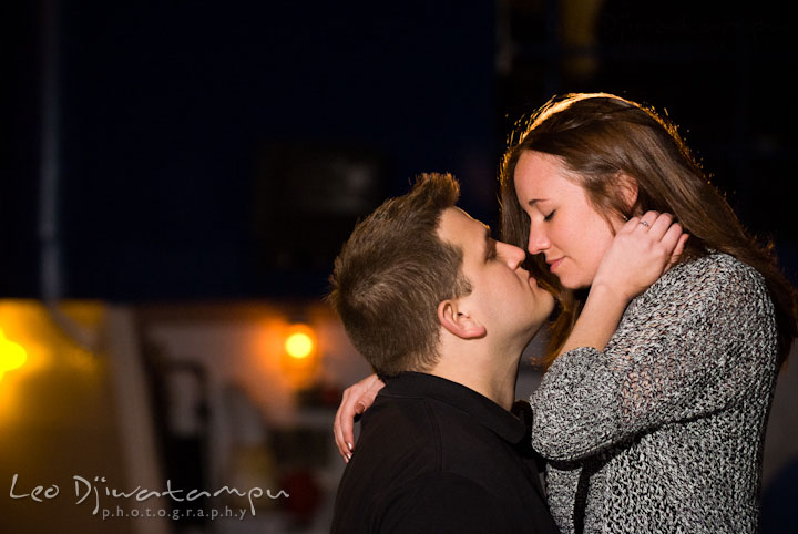 Engaged guy and his fiancée almost kissed. Fells Point Baltimore Maryland pre-wedding engagement photo session with their dog pet by wedding photographers of Leo Dj Photography