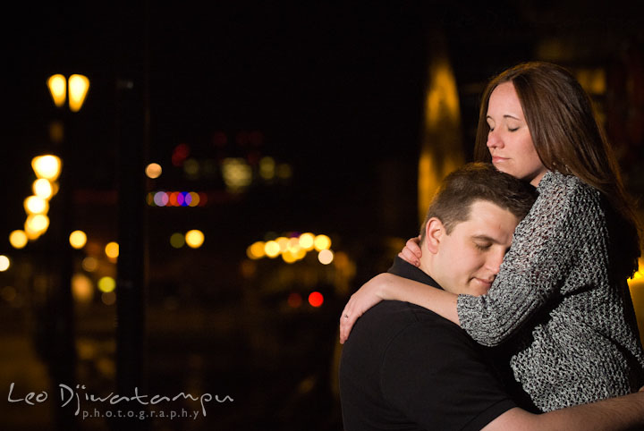 Engaged girl hugging her fiancé. Fells Point Baltimore Maryland pre-wedding engagement photo session with their dog pet by wedding photographers of Leo Dj Photography