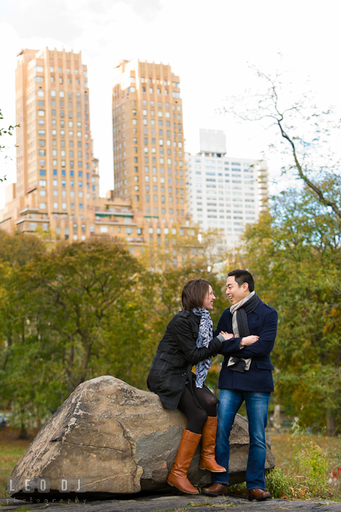 Engaged couple chatting and laughing together at Central Park. Pre-wedding engagement photo session at New York City, NY, by wedding photographers of Leo Dj Photography. http://leodjphoto.com